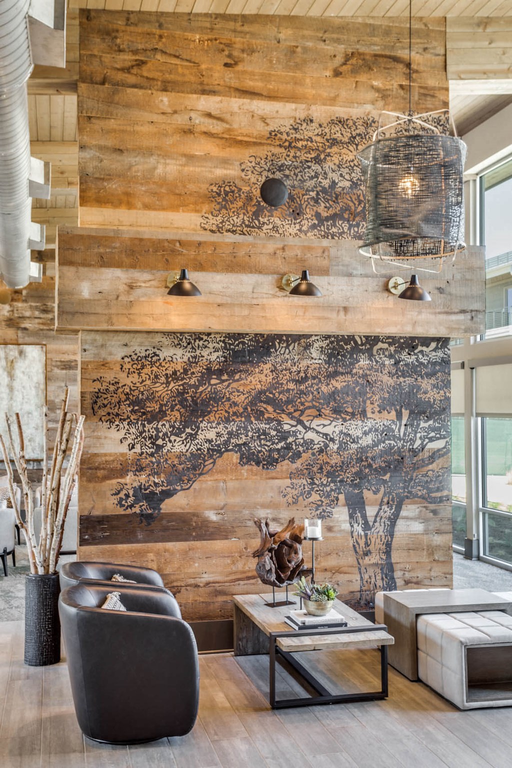 a living room with a tree mural on the wall