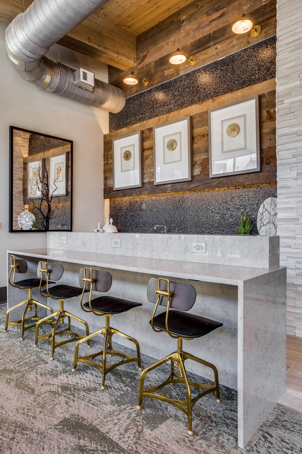 a bar with chairs in a room with a marble counter