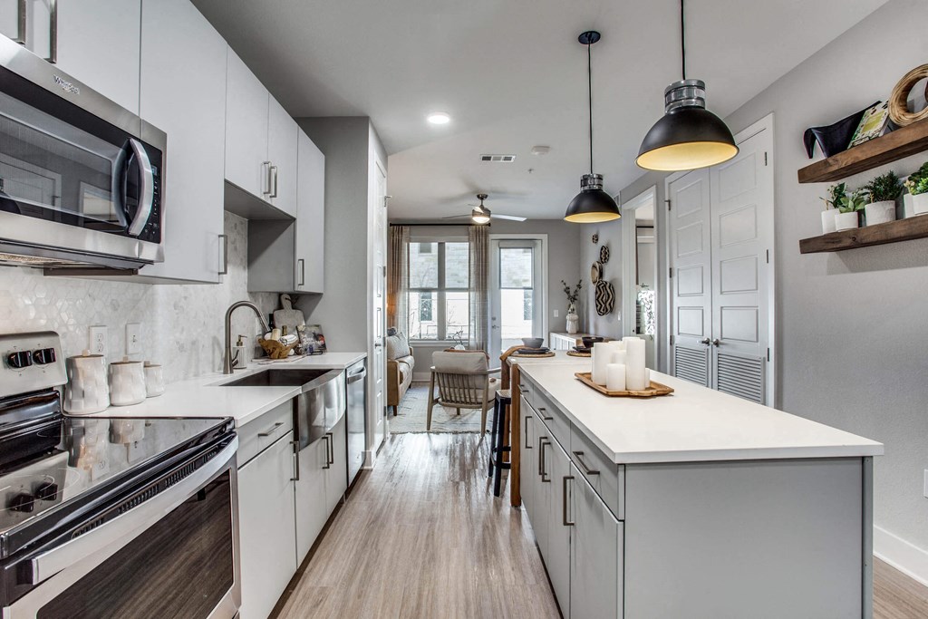 a kitchen with white cabinets and a white counter top