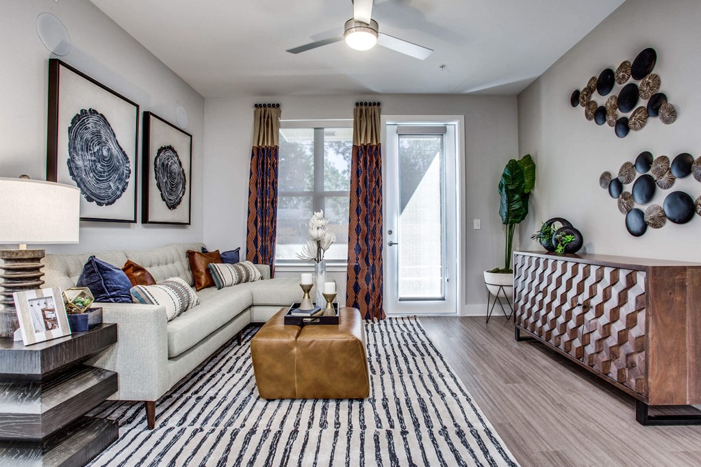 a living room with a white couch and a sliding glass door