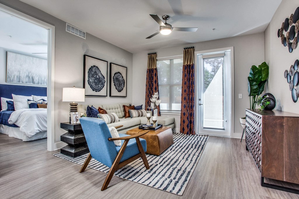 a living room with a couch and a table     and a bedroom