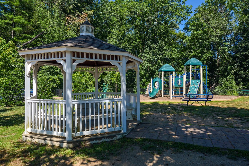 a gazebo with a playground in a park