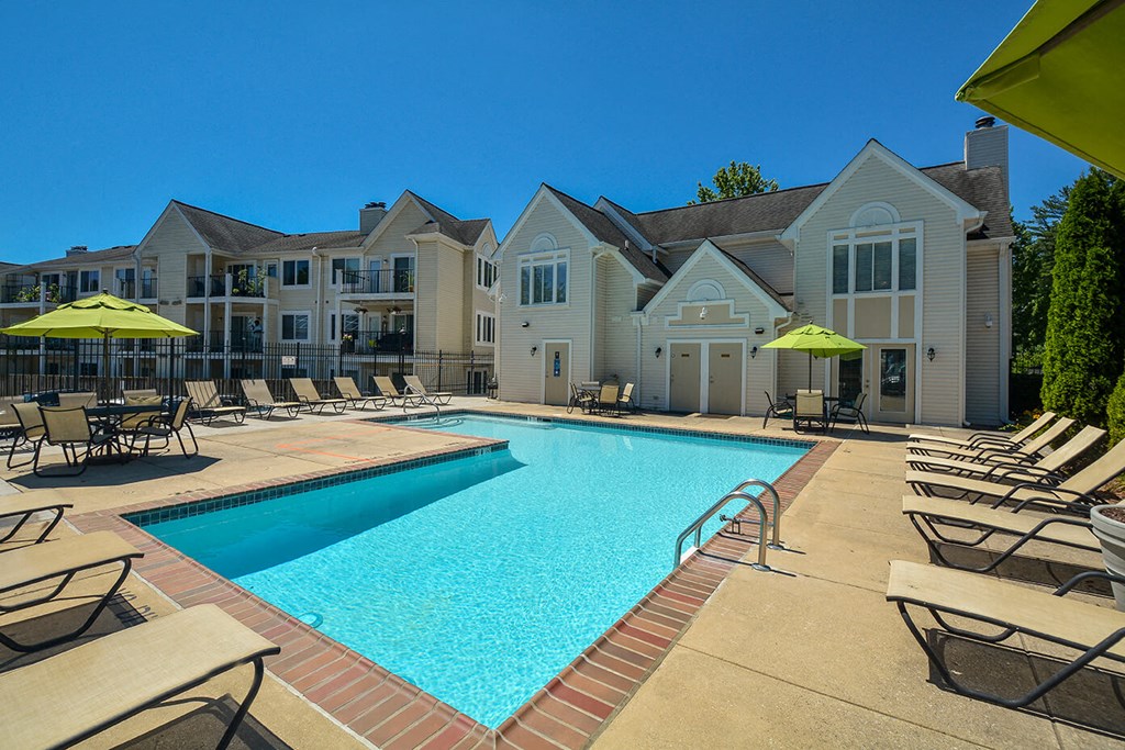 our apartments have a swimming pool with chairs and umbrellas