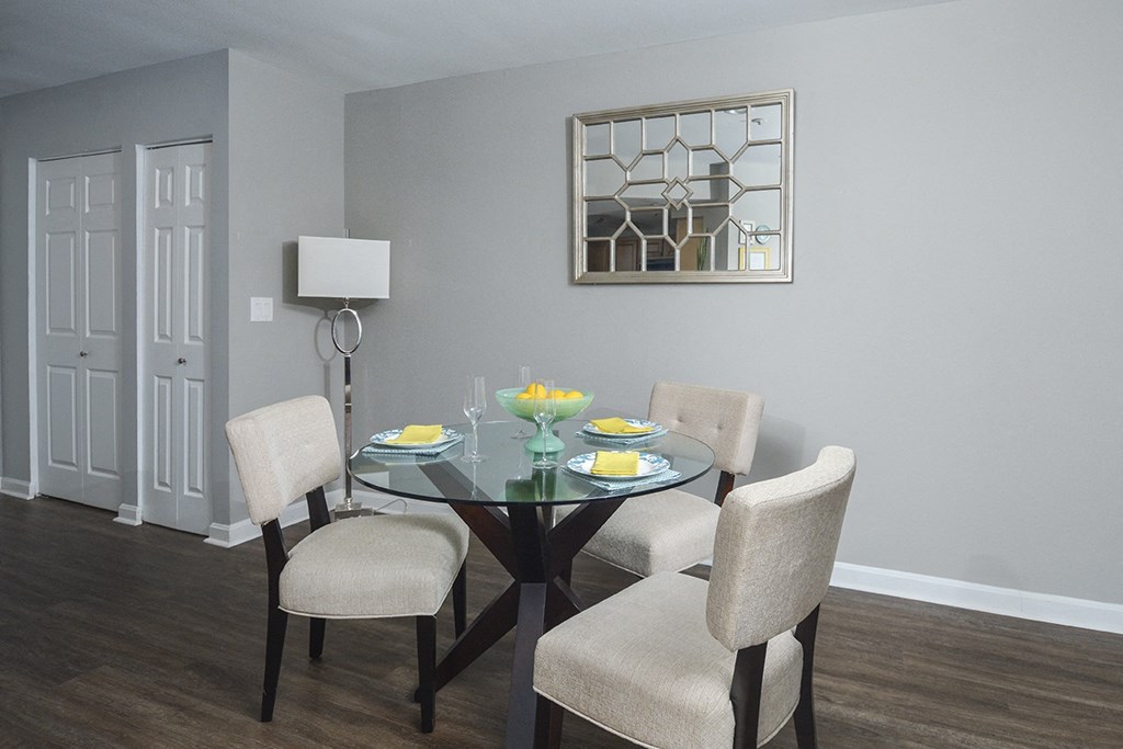 a dining room with a table and chairs and a window
