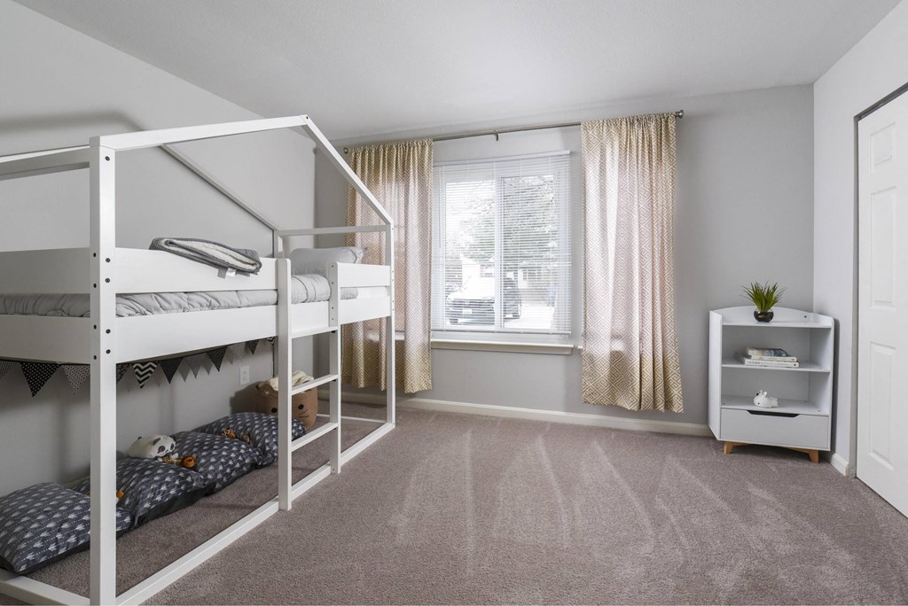 a kids bedroom with bunk beds and a window