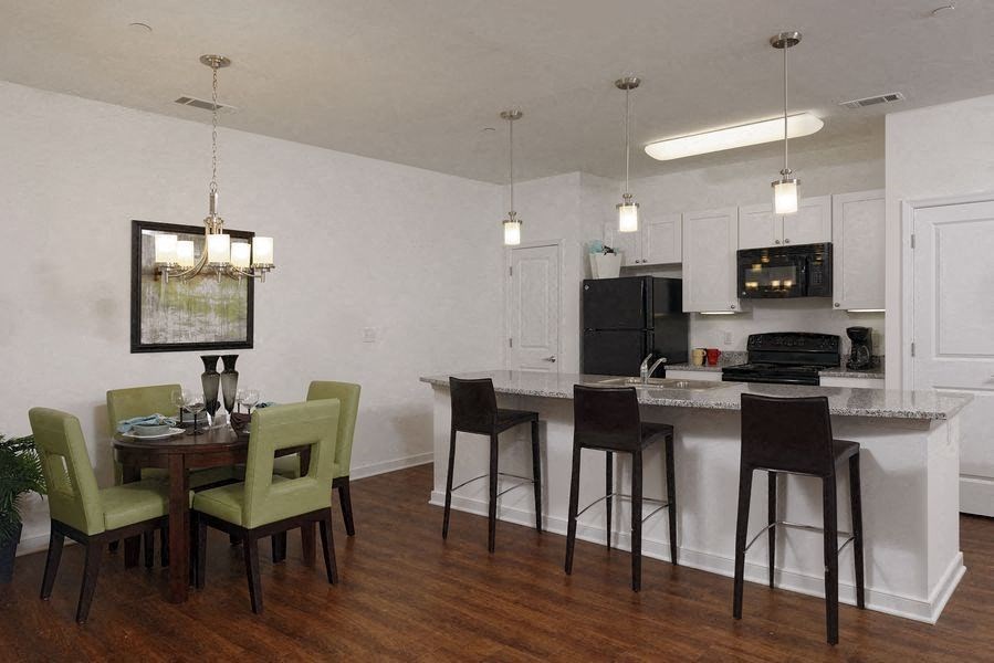 a kitchen and dining room with a table and chairs