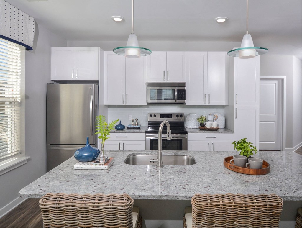 a kitchen with white cabinets and a counter top