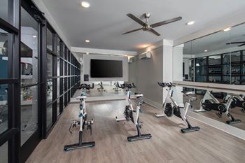 a workout room with weights and a tv in a home gym