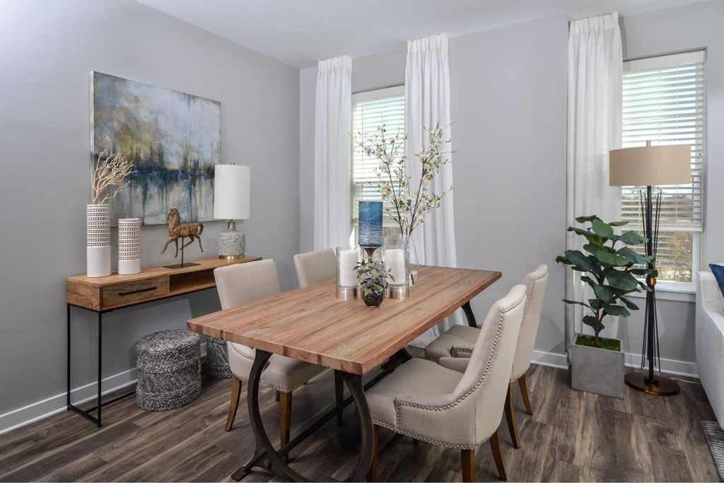 a dining room with a wooden table and white chairs