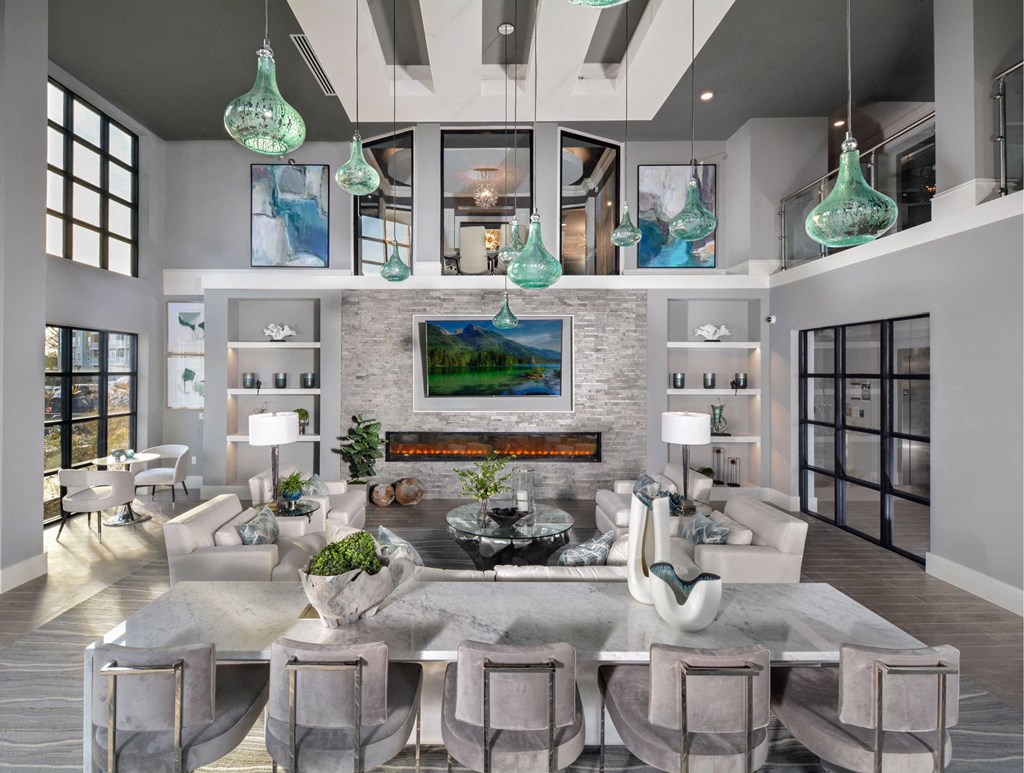 a living room with a table and chairs and a fireplace