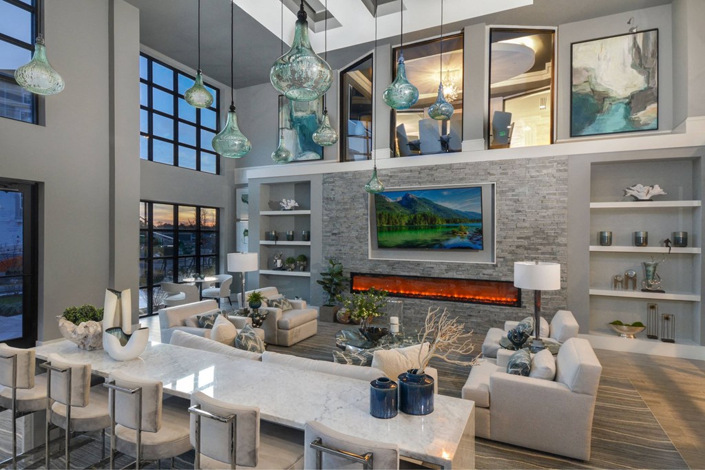 a living room with a fireplace and a table with chairs