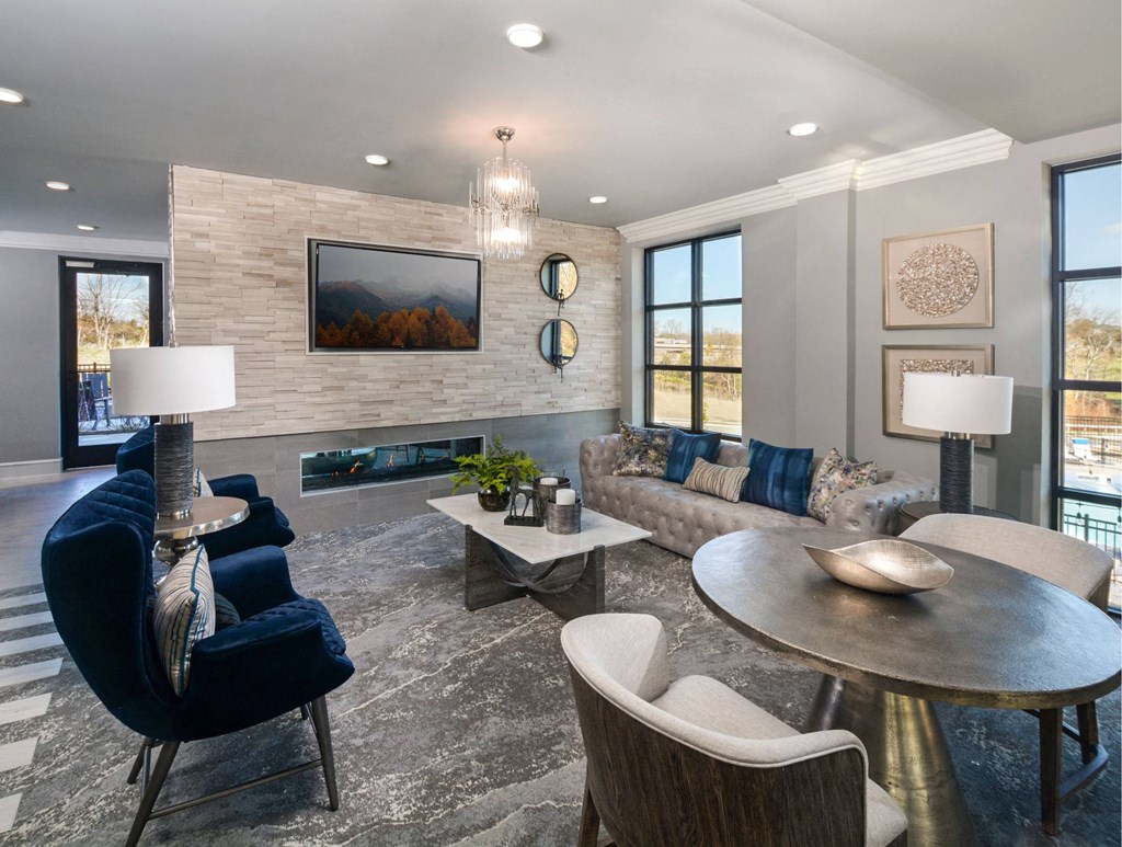 a living room with couches and chairs and a table