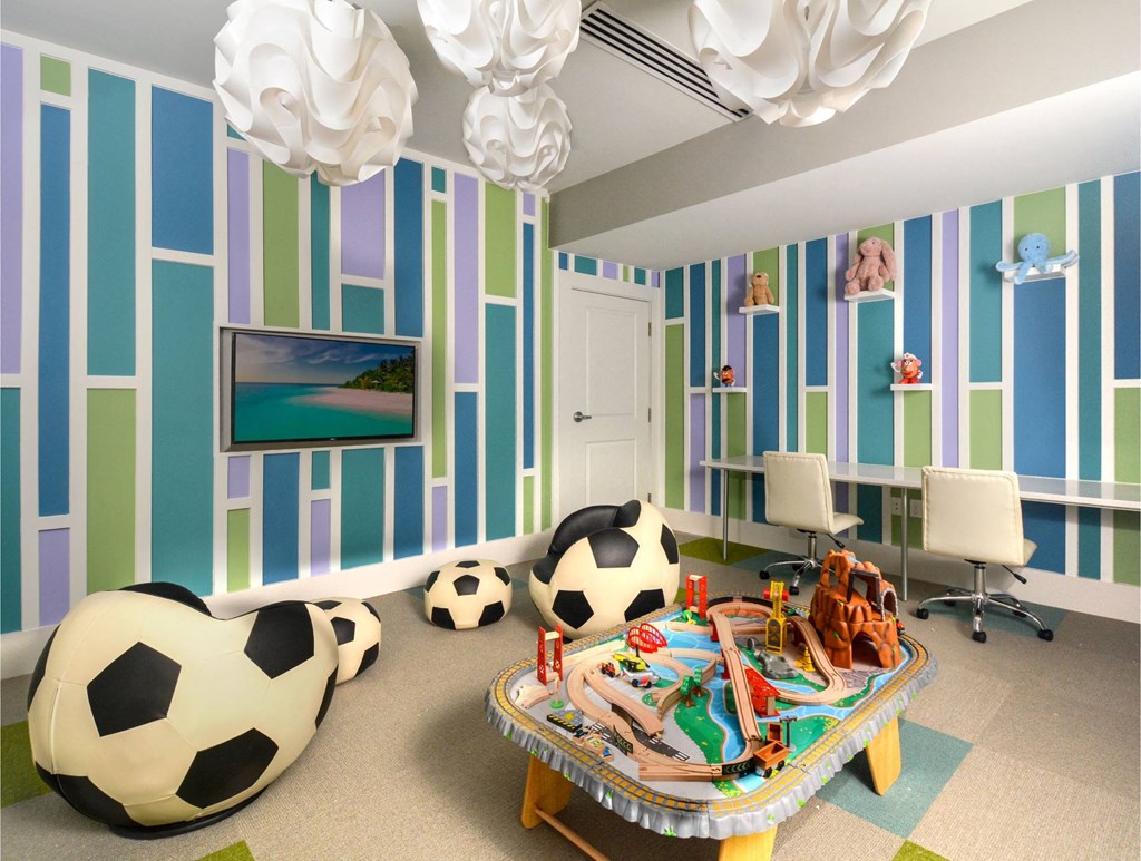 a childs play room with soccer balls and a table