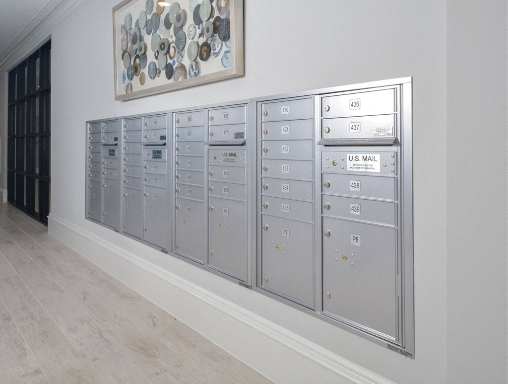 a row of lockers in a room with a painting on the wall