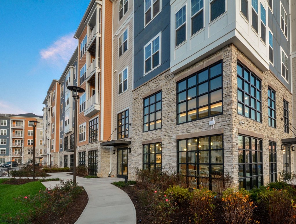 a large building with a sidewalk in front of it