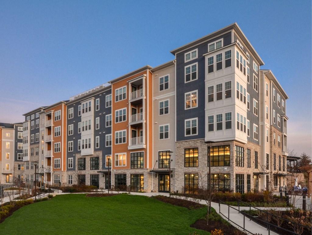 an exterior view of an apartment building at dusk