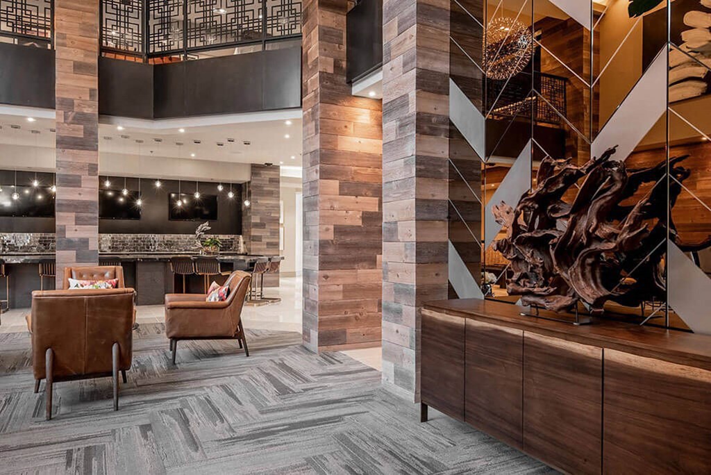 a lobby of a hotel with chairs and a bar