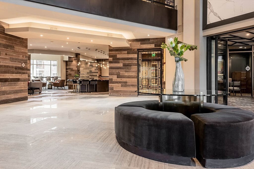 the lobby or reception area of a hotel with black furniture