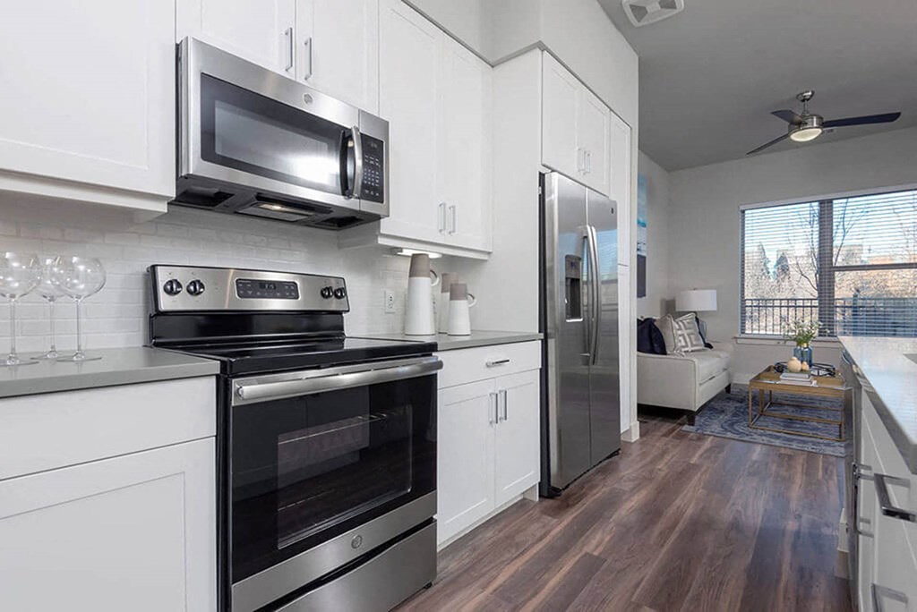 a kitchen with stainless steel appliances and white cabinets