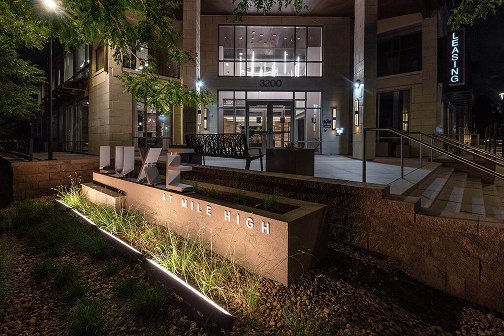 a night view of the entrance to in mile high at night