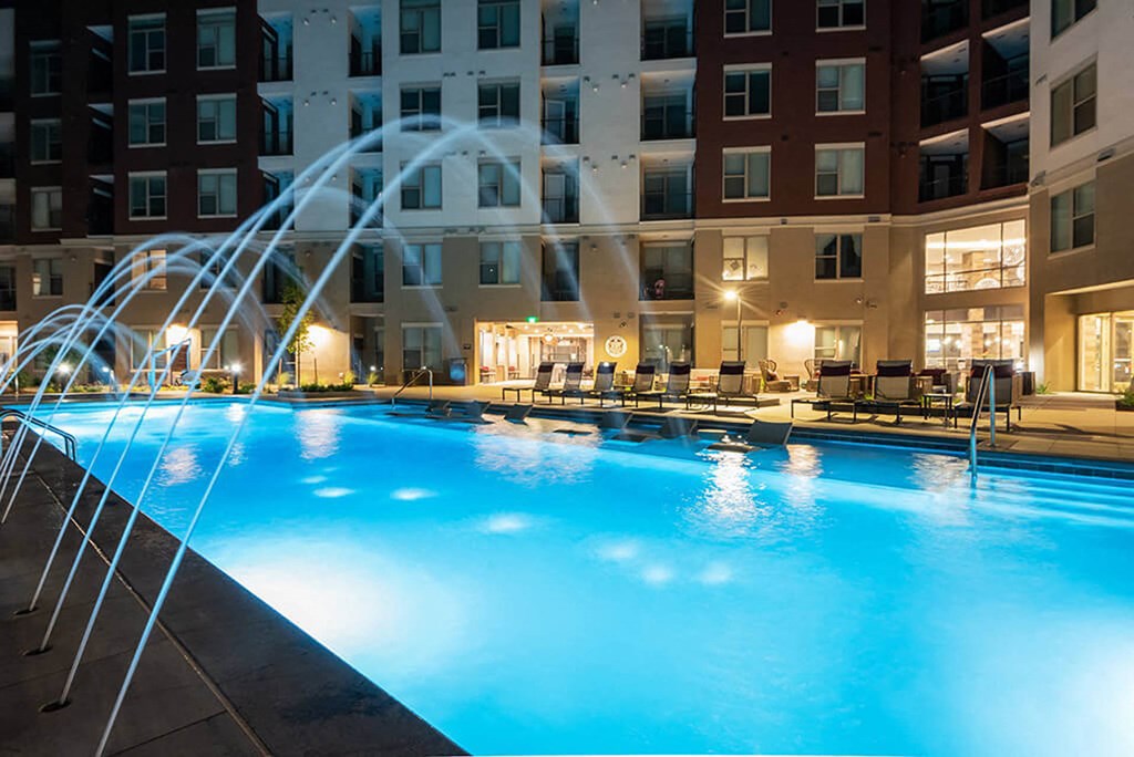 a swimming pool at a hotel with a water fountain