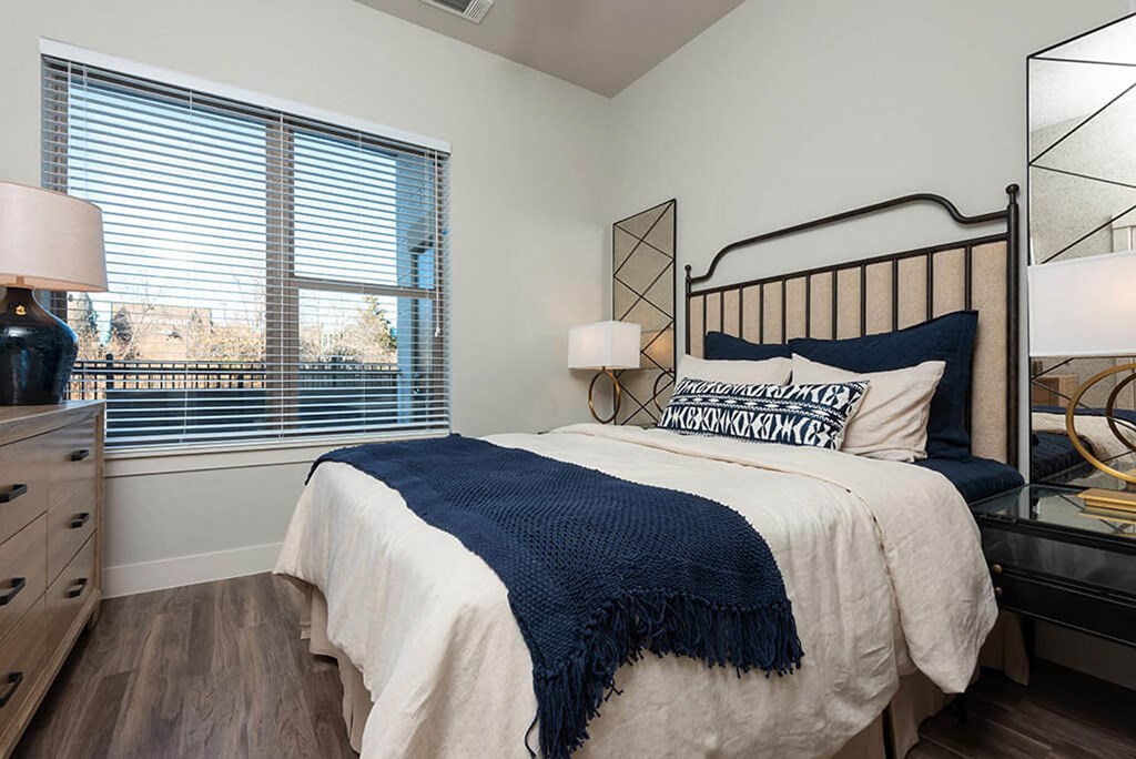 a bedroom with a bed and a large window