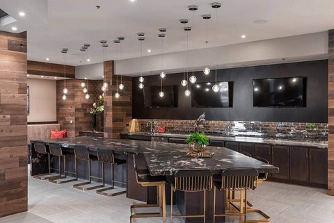 a large kitchen with a large island and chairs