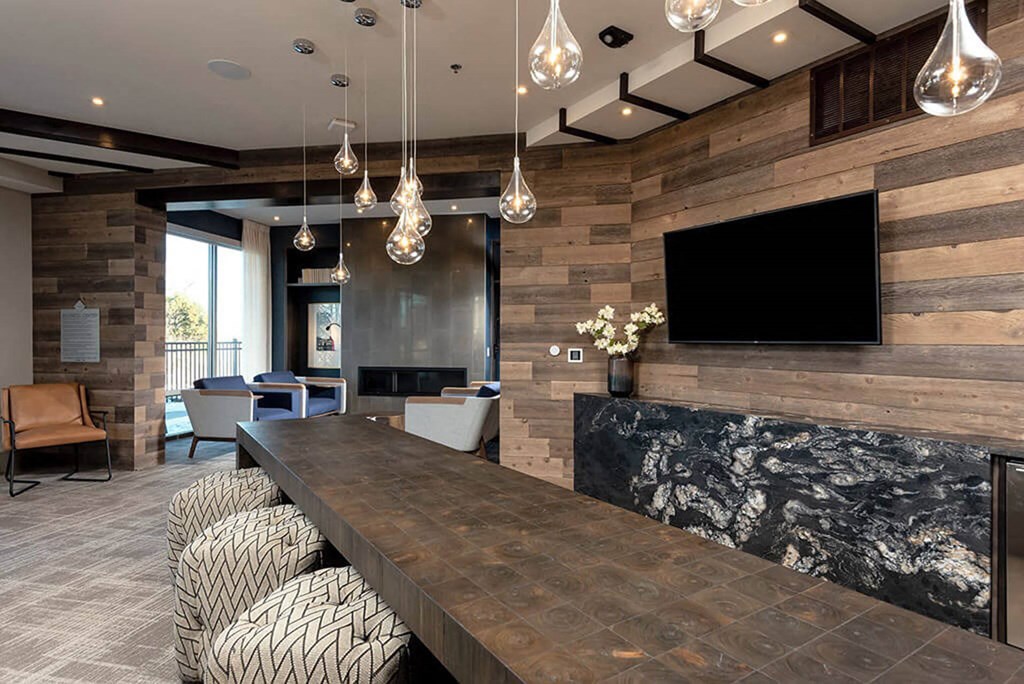 a large living room with a long table and a tv