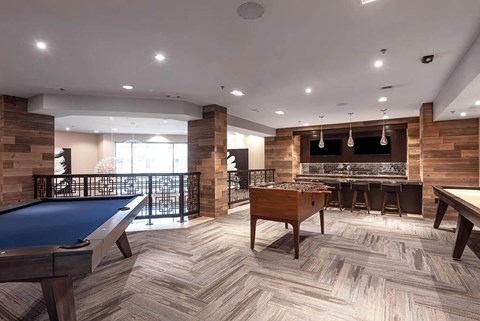 a game room with a pool table and a bar