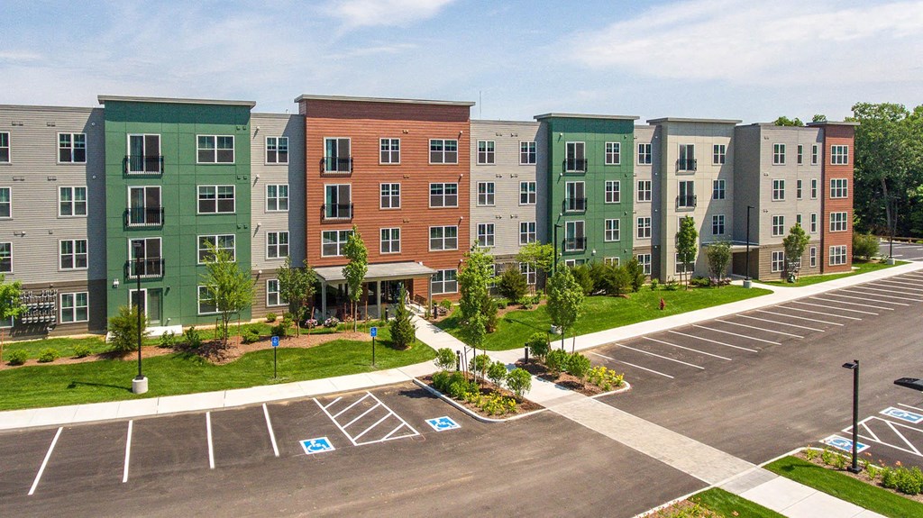 an aerial view of an apartment building in a parking lot