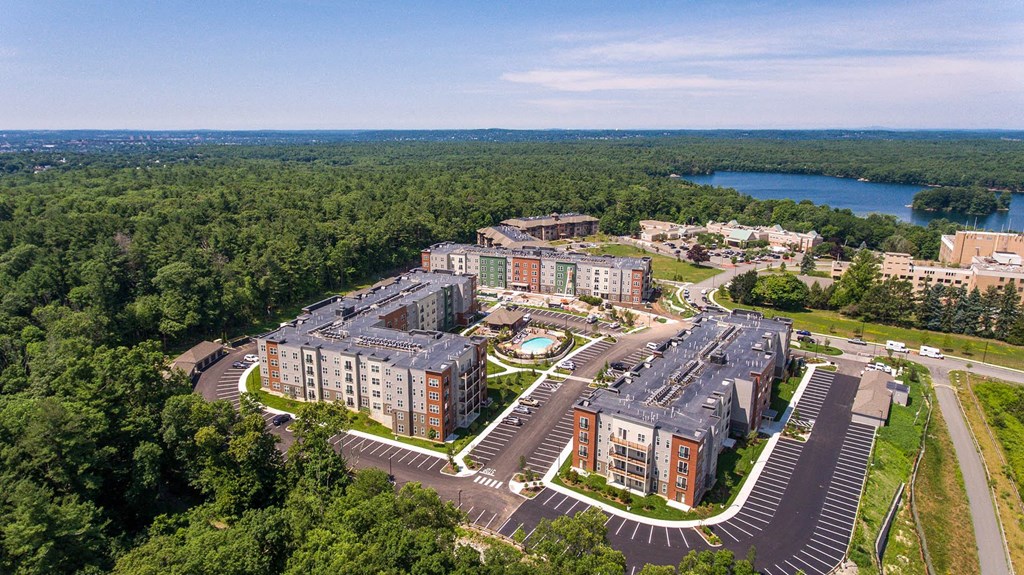 an aerial view of a city with buildings and a lake