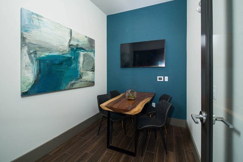 a dining room with a table and chairs and a television