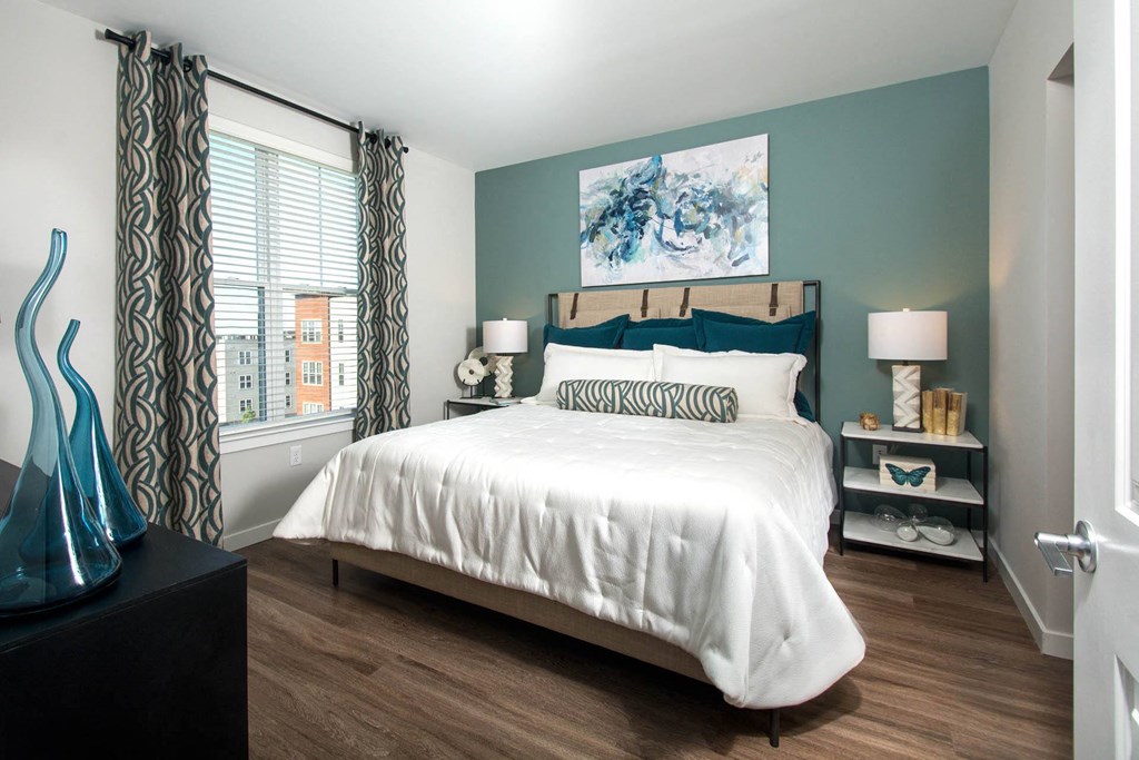 a bedroom with a bed and a large window