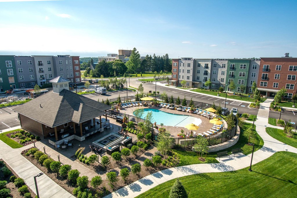 an aerial view of a swimming pool in front of a building