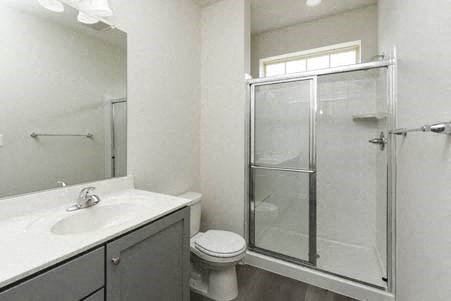 a bathroom with a shower toilet and a sink