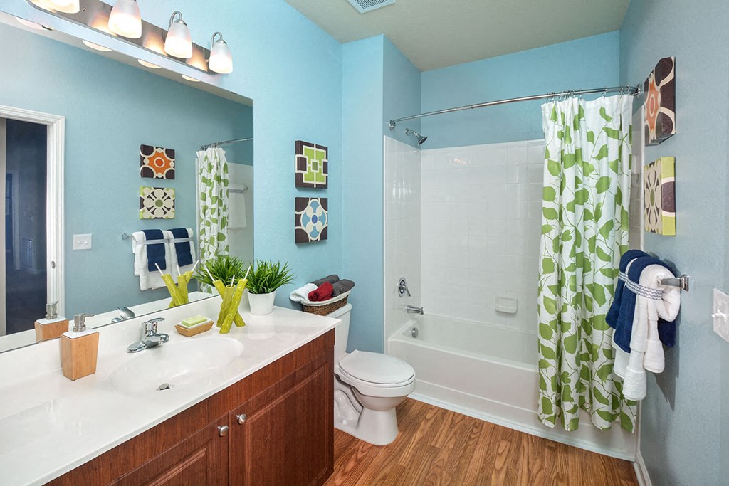 a bathroom with a shower and a sink and a toilet