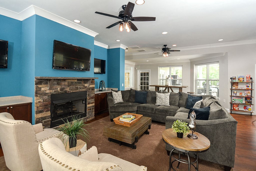 a living room with blue walls and a fireplace