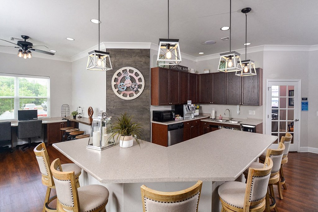 a kitchen with a large island and a clock on the wall