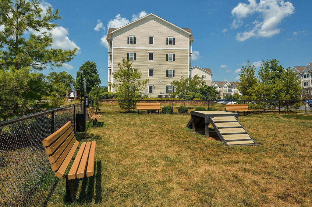 a park with benches and a table in front of a building