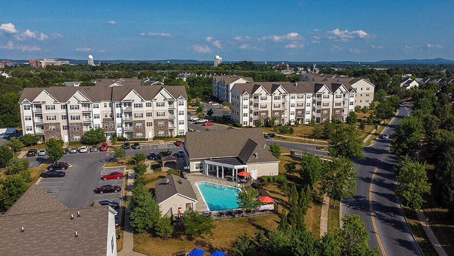 an aerial view of an apartment complex with a swimming pool