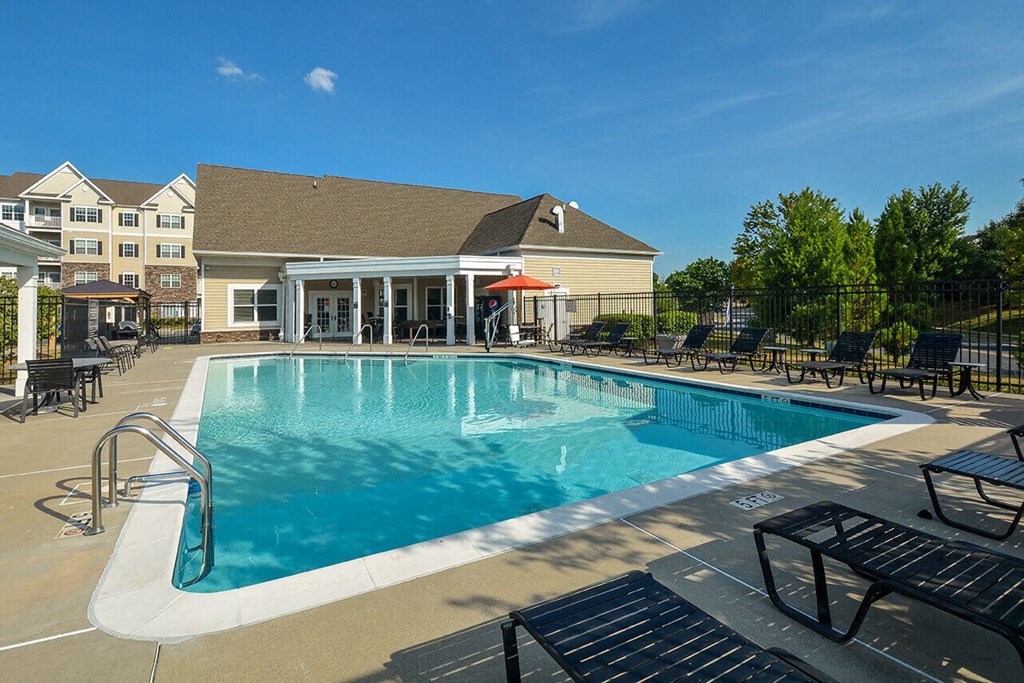 a swimming pool with a building in the background