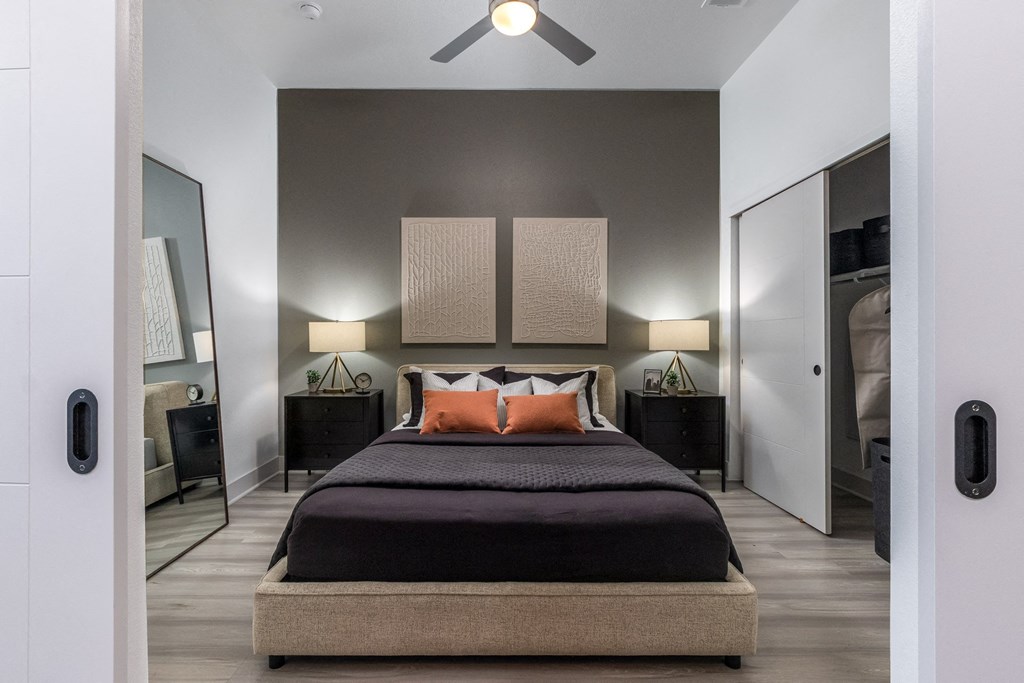 a bedroom with a bed and a ceiling fan