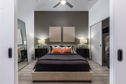 a bedroom with a bed and a ceiling fan