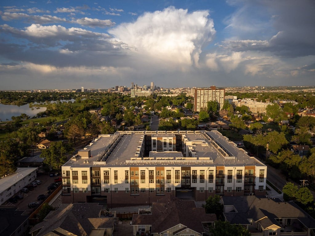 an aerial view of a building with a city in the background