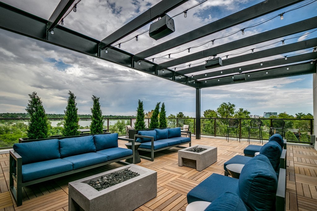 a roof top patio with blue couches and tables