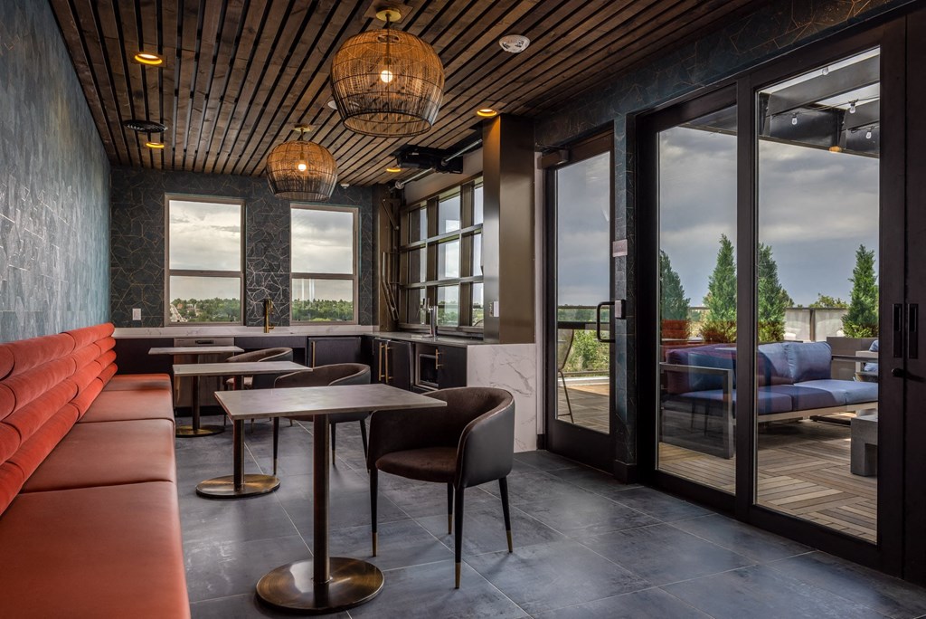 a restaurant with tables and chairs and large windows