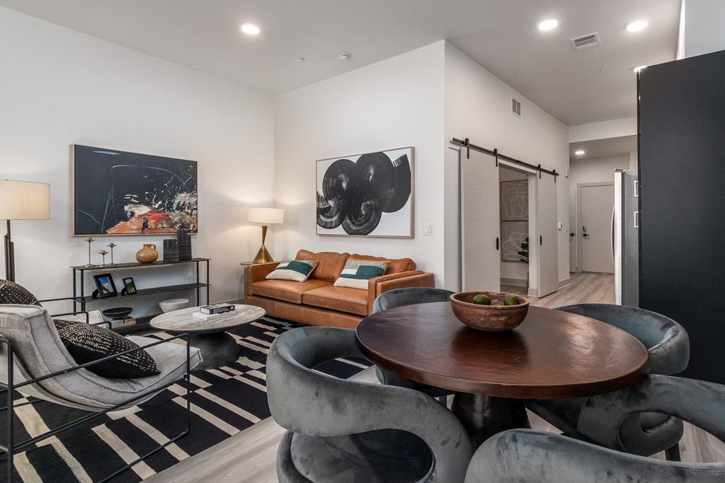 a living room with couches and chairs and a table