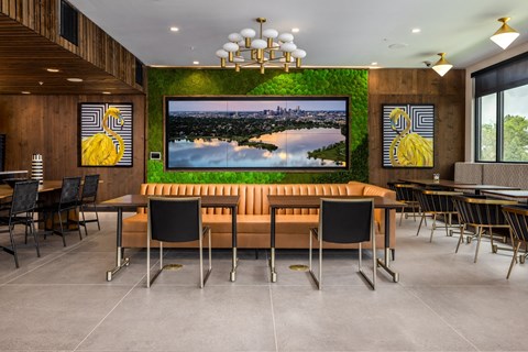 a dining room with a table and chairs and a picture on the wall