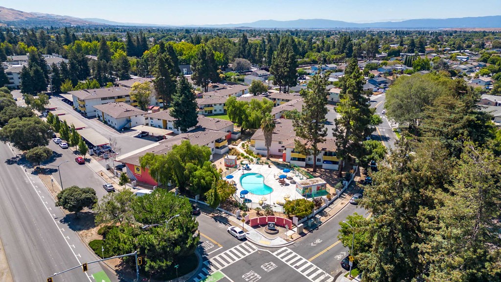a aerial view of a resort with a pool and trees