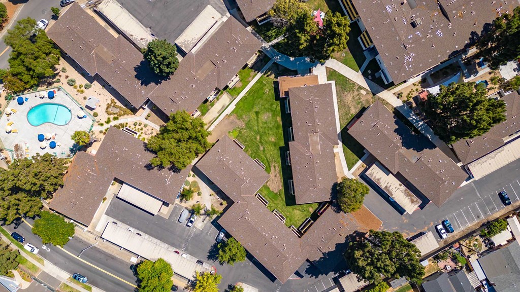 an aerial view of a neighborhood with houses and a pool